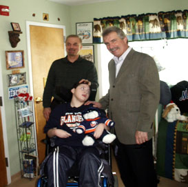 Former New York Islander and Hockey Hall of Famer Clark Gilles is seen with Eric and his dad on a recent visit to Angela's House